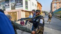 مقاتلون من طالبان يمنعون صحافيين من أداء عملهم ويوجه أحدهم بندقيته لرأس مصور (بولنت كيليك/فرانس برس)
