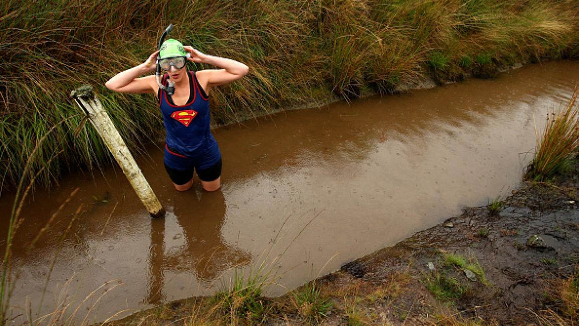 LLANWRTYD WELLS, UNITED KINGDOM - AUGUST 31: A competitor takes part in the World Bog Snorkelling Championships held at Waen Rhydd Bog on August 31, 2009 in Llanwrtyd Wells, Wales. (Photo by Richard Heathcote/Getty Images)	